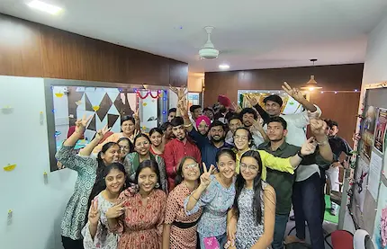 Students cheer together for a fun group photo after class