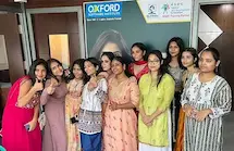 Students in formal wear pose confidently after completing their session